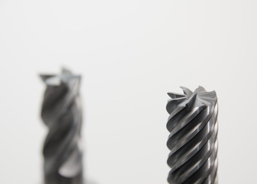 Detailed view of spiral metal drill bits used in precision machining and metalworking.