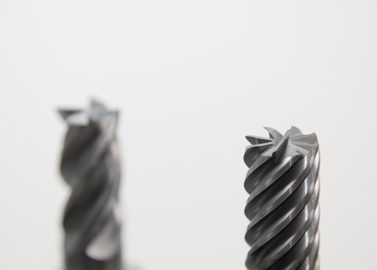 Detailed view of spiral metal drill bits used in precision machining and metalworking.